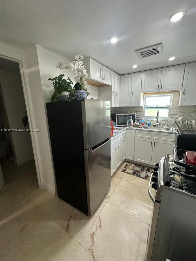 1249 S Flamingo Rd, Davie, FL 33325 - kitchen featuring appliances with stainless steel finishes, white cabinetry, light countertops, and recessed lighting