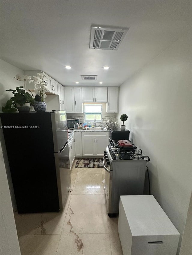 1249 S Flamingo Rd, Davie, FL 33325 - kitchen featuring appliances with stainless steel finishes, white cabinetry, and recessed lighting