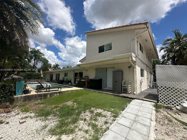 1249 S Flamingo Rd, Davie, FL 33325 - back of house with stucco siding, an outdoor pool, and a patio