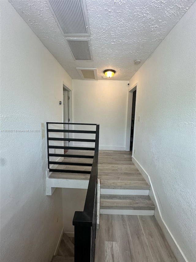 1249 S Flamingo Rd, Davie, FL 33325 - stairway with a textured ceiling and wood finished floors