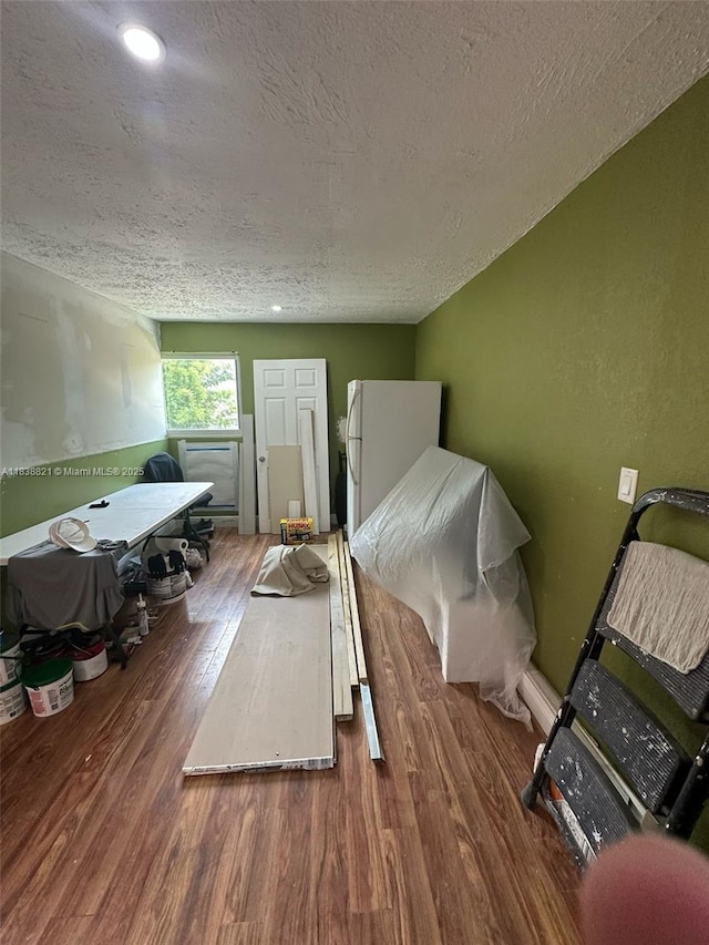 1249 S Flamingo Rd, Davie, FL 33325 - bedroom with a textured ceiling, wood finished floors, and freestanding refrigerator