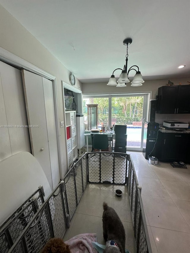 1249 S Flamingo Rd, Davie, FL 33325 - kitchen with a chandelier, light tile patterned flooring, a desk, hanging light fixtures, and dark cabinets