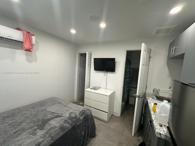1249 S Flamingo Rd, Davie, FL 33325 - bedroom with a wall unit AC, attic access, recessed lighting, and freestanding refrigerator