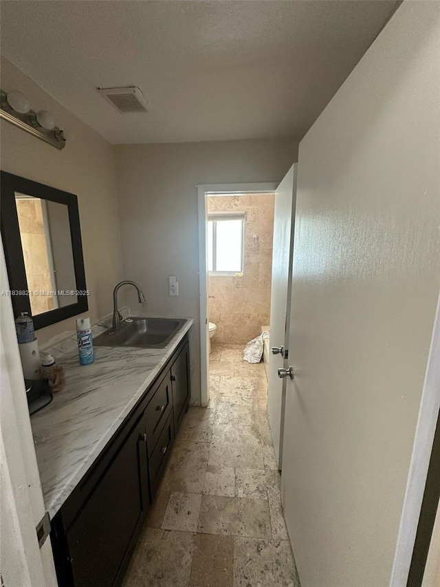 1249 S Flamingo Rd, Davie, FL 33325 - bathroom featuring double vanity and stone finish floors