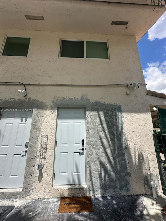 1249 S Flamingo Rd, Davie, FL 33325 - doorway to property with stucco siding and a surveillance system
