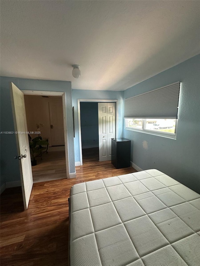 1249 S Flamingo Rd, Davie, FL 33325 - unfurnished bedroom featuring dark wood-type flooring and a closet