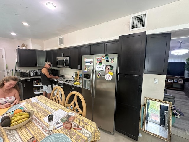1249 S Flamingo Rd, Davie, FL 33325 - kitchen with appliances with stainless steel finishes, dark cabinetry, light tile patterned floors, and recessed lighting