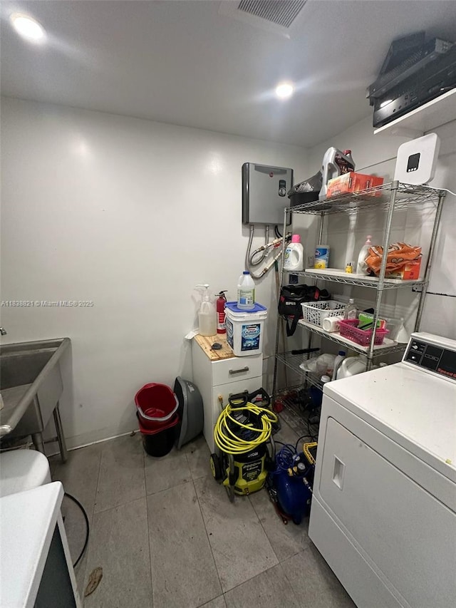 1249 S Flamingo Rd, Davie, FL 33325 - laundry area with washer / dryer and tile patterned flooring