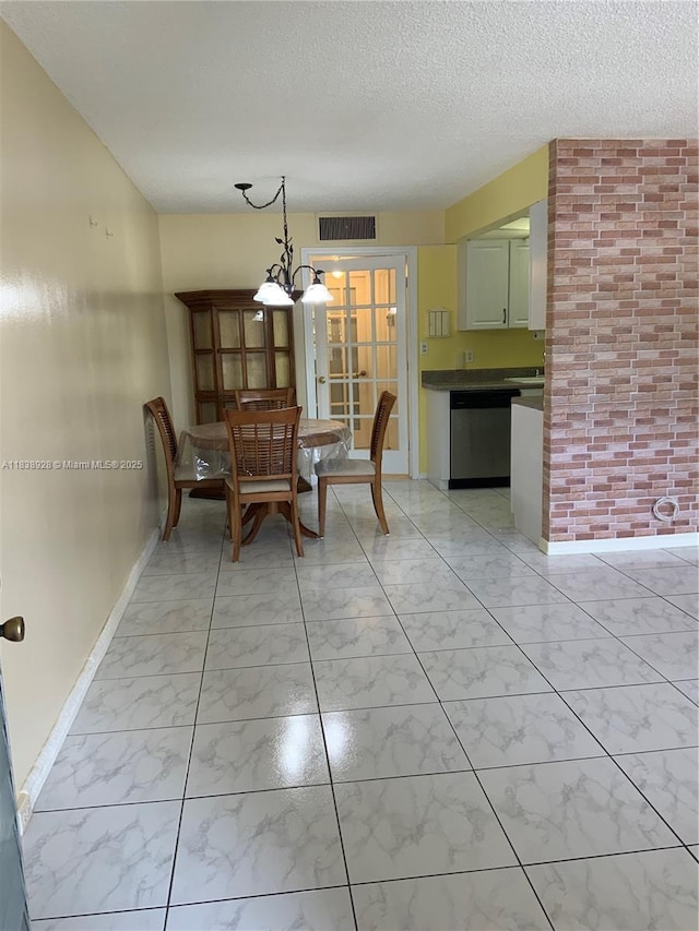 2405 Antigua Cir Unit H1, Coconut Creek, FL 33066 - dining space with light marble finish flooring, a textured ceiling, and a chandelier
