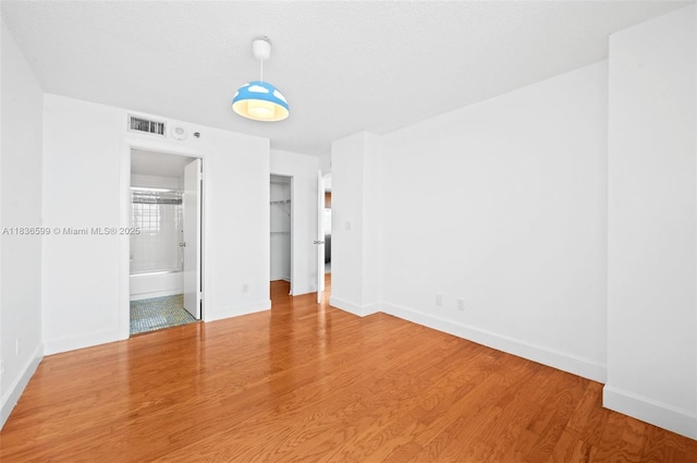 770 Claughton Island Dr Unit 1915, Miami, FL 33131 - unfurnished bedroom featuring wood finished floors, ensuite bathroom, and a spacious closet