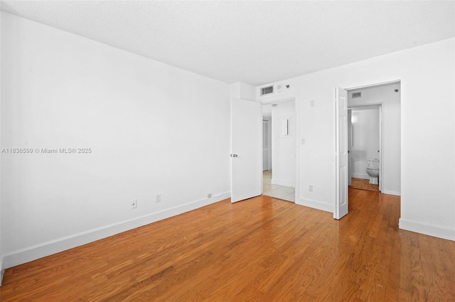 770 Claughton Island Dr Unit 1915, Miami, FL 33131 - unfurnished bedroom featuring baseboards and light wood finished floors