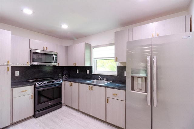 5387 SW 40th Ave Unit 202, Dania Beach, FL 33314 - kitchen with appliances with stainless steel finishes, dark countertops, tasteful backsplash, and recessed lighting