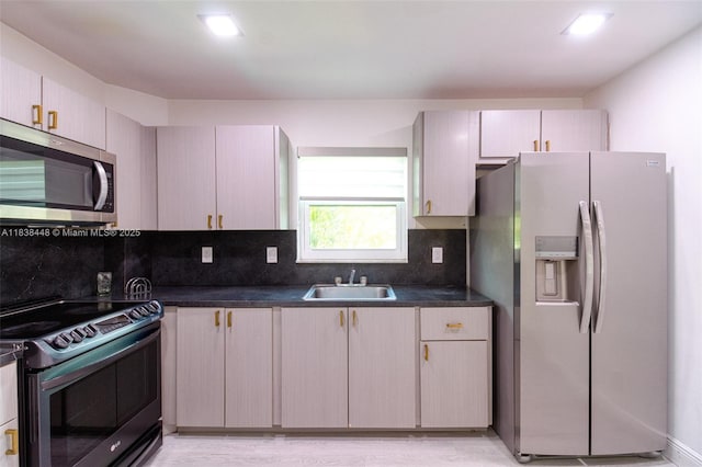 5387 SW 40th Ave Unit 202, Dania Beach, FL 33314 - kitchen with appliances with stainless steel finishes, dark countertops, backsplash, and light wood finished floors