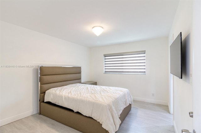 5387 SW 40th Ave Unit 202, Dania Beach, FL 33314 - bedroom with light wood-type flooring and baseboards