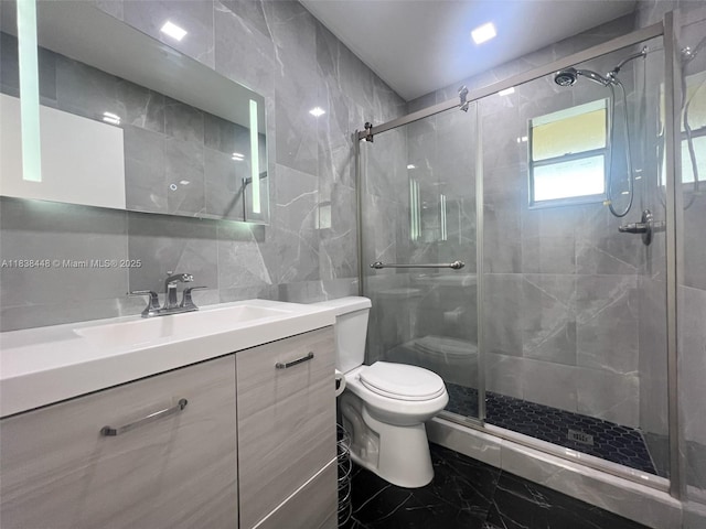 5387 SW 40th Ave Unit 202, Dania Beach, FL 33314 - bathroom with tile walls, marble finish floors, a stall shower, and vanity