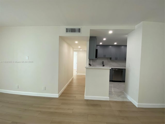 4400 Hillcrest Dr Unit 314B, Hollywood, FL 33021 - kitchen featuring stainless steel dishwasher, light wood-type flooring, recessed lighting, gray cabinetry, and light countertops