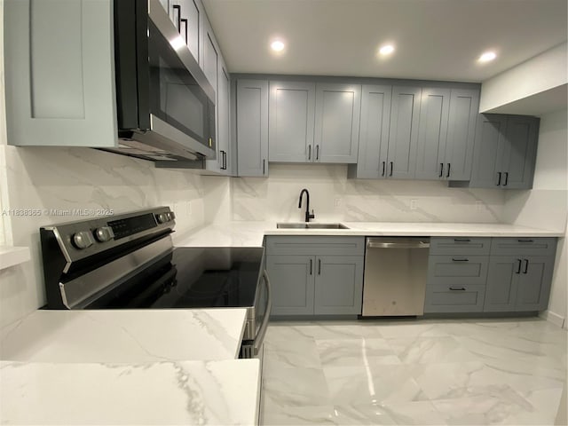 4400 Hillcrest Dr Unit 314B, Hollywood, FL 33021 - kitchen featuring stainless steel appliances, gray cabinetry, tasteful backsplash, light marble finish floors, and recessed lighting