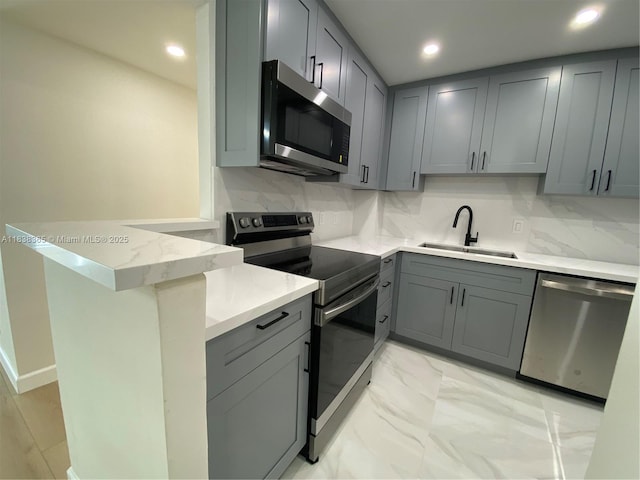 4400 Hillcrest Dr Unit 314B, Hollywood, FL 33021 - kitchen featuring stainless steel appliances, gray cabinetry, recessed lighting, a peninsula, and decorative backsplash