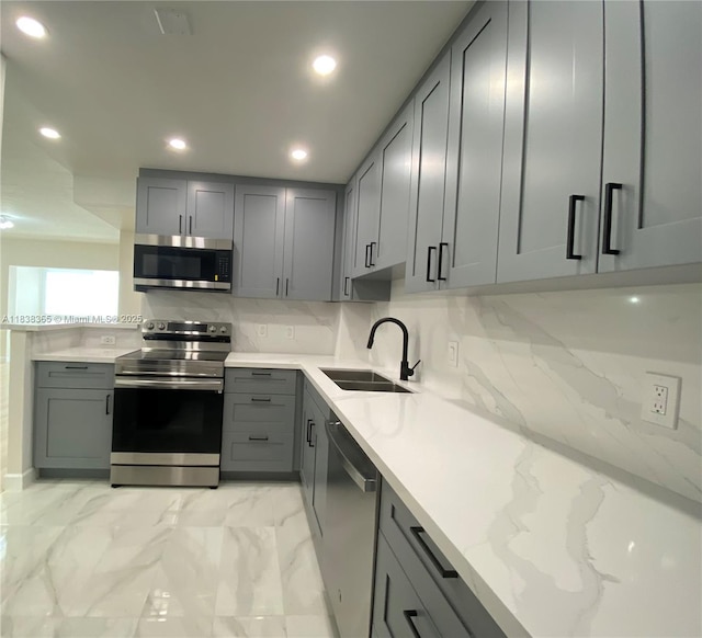 4400 Hillcrest Dr Unit 314B, Hollywood, FL 33021 - kitchen featuring appliances with stainless steel finishes, gray cabinets, light marble finish floors, tasteful backsplash, and recessed lighting