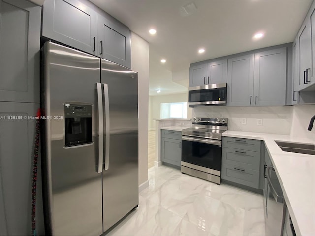 4400 Hillcrest Dr Unit 314B, Hollywood, FL 33021 - kitchen with stainless steel appliances, gray cabinets, light marble finish floors, recessed lighting, and light countertops