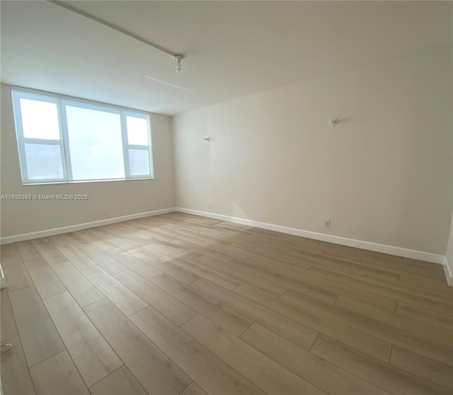 4400 Hillcrest Dr Unit 314B, Hollywood, FL 33021 - spare room featuring wood finished floors and baseboards