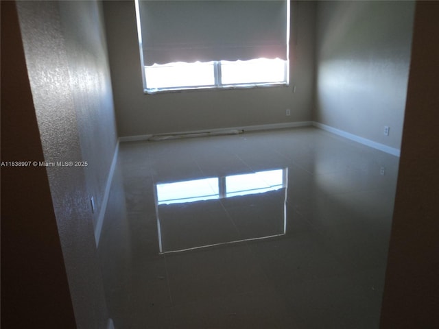 1050 93rd St Unit 6F, Bay Harbor Islands, FL 33154 - spare room with plenty of natural light and tile patterned flooring