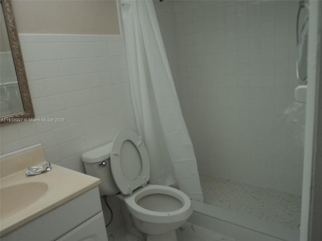 1050 93rd St Unit 6F, Bay Harbor Islands, FL 33154 - full bathroom with tile walls, vanity, a stall shower, and wainscoting