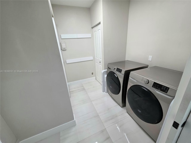 10120 NW 71st Pl, Tamarac, FL 33321 - washroom with washing machine and dryer and baseboards