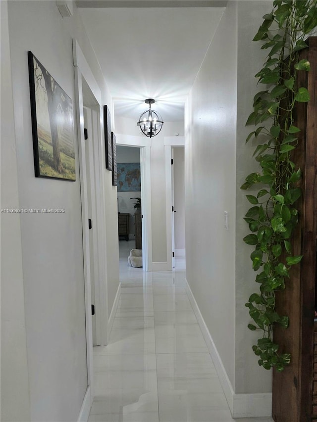 10120 NW 71st Pl, Tamarac, FL 33321 - corridor featuring a chandelier and baseboards
