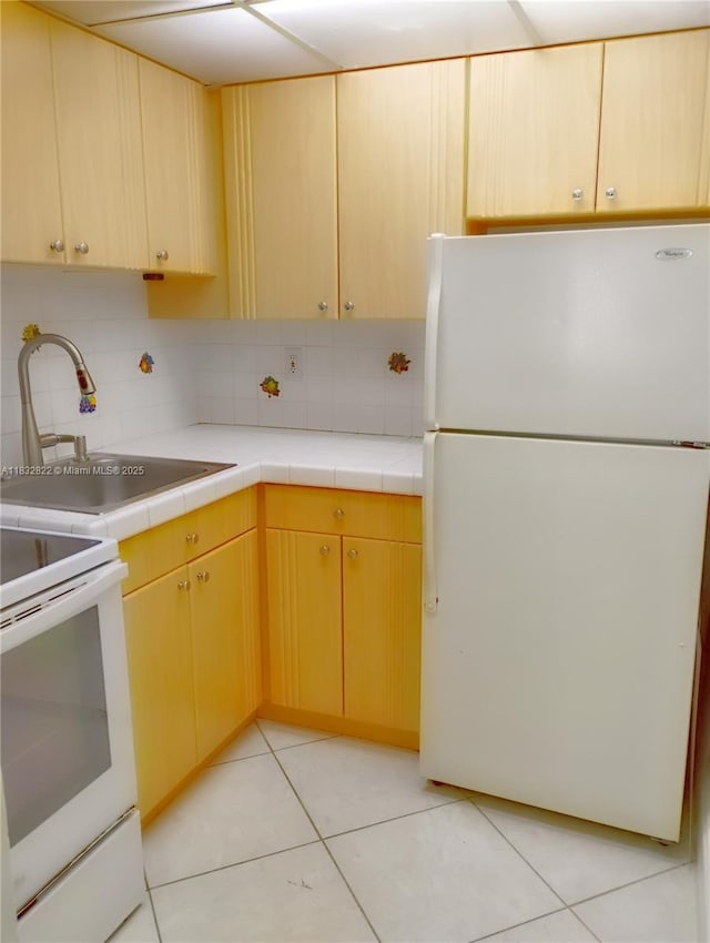 8605 SW 68th Ct Unit 22, Pinecrest, FL 33156 - kitchen featuring white appliances, backsplash, tile countertops, and light tile patterned flooring