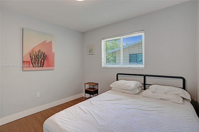 16000 N Miami Ave, Miami, FL 33169 - bedroom featuring baseboards and wood finished floors