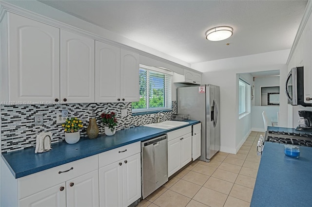16000 N Miami Ave, Miami, FL 33169 - kitchen featuring stainless steel appliances, dark countertops, light tile patterned flooring, and decorative backsplash