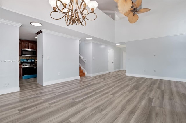 14834 SW 140th St, Miami, FL 33196 - unfurnished living room featuring stairway, a chandelier, light wood-style flooring, a ceiling fan, and ornamental molding