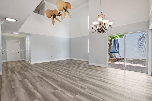 14834 SW 140th St, Miami, FL 33196 - unfurnished room featuring crown molding, wood finished floors, high vaulted ceiling, a chandelier, and a ceiling fan