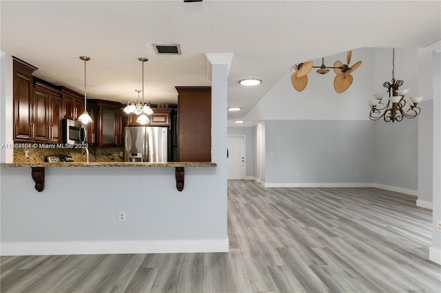 14834 SW 140th St, Miami, FL 33196 - kitchen with stainless steel appliances, a chandelier, stone countertops, a breakfast bar, and recessed lighting