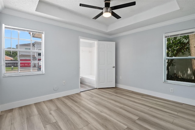 14834 SW 140th St, Miami, FL 33196 - unfurnished bedroom with a raised ceiling, light wood-style floors, ornamental molding, ensuite bath, and a ceiling fan