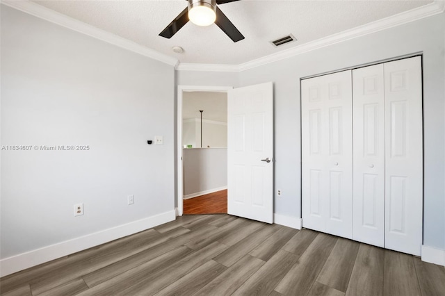 14834 SW 140th St, Miami, FL 33196 - unfurnished bedroom featuring crown molding, wood finished floors, a closet, and a ceiling fan