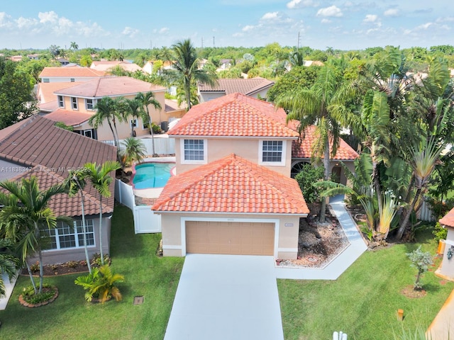 18232 SW 5th St, Pembroke Pines, FL 33029 - view of front facade featuring a tiled roof, concrete driveway, stucco siding, an attached garage, and a fenced backyard