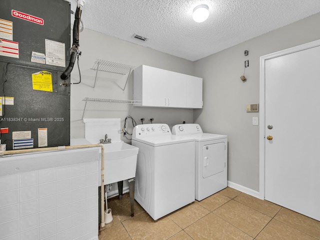 18232 SW 5th St, Pembroke Pines, FL 33029 - laundry area featuring independent washer and dryer, heating unit, a textured ceiling, light tile patterned floors, and cabinet space
