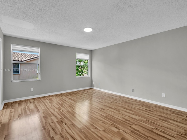 18232 SW 5th St, Pembroke Pines, FL 33029 - empty room with wood finished floors and a textured ceiling