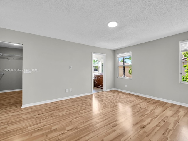 18232 SW 5th St, Pembroke Pines, FL 33029 - empty room with a textured ceiling and light wood-type flooring