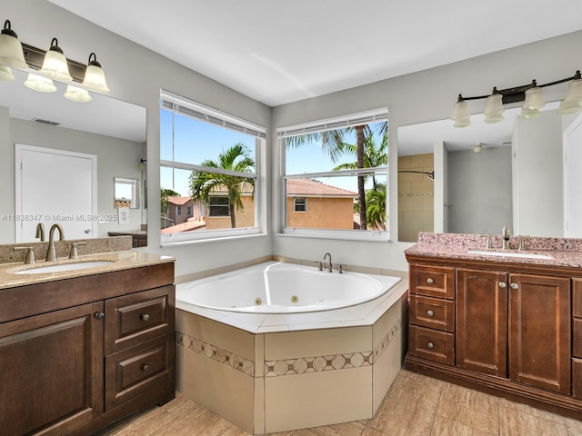 18232 SW 5th St, Pembroke Pines, FL 33029 - full bathroom featuring two vanities, a whirlpool tub, and plenty of natural light
