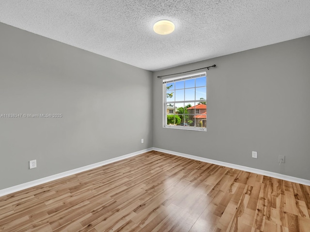 18232 SW 5th St, Pembroke Pines, FL 33029 - spare room with a textured ceiling and wood finished floors