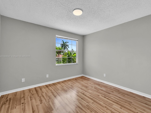 18232 SW 5th St, Pembroke Pines, FL 33029 - unfurnished room with light wood-style floors and a textured ceiling
