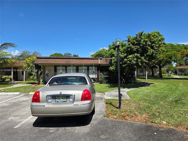 3635 SW Natura Ave Unit A, Deerfield Beach, FL 33441 - ranch-style house with a front lawn and uncovered parking