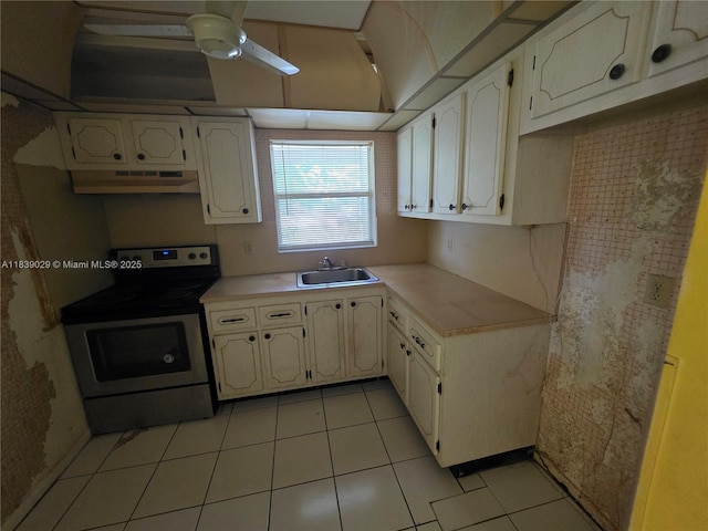 3635 SW Natura Ave Unit A, Deerfield Beach, FL 33441 - kitchen with stainless steel electric range, under cabinet range hood, light countertops, a ceiling fan, and light tile patterned floors
