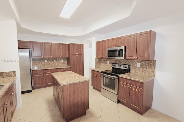 3001 SW 156th Ave, Miami, FL 33185 - kitchen with appliances with stainless steel finishes, a raised ceiling, backsplash, a center island, and light tile patterned floors