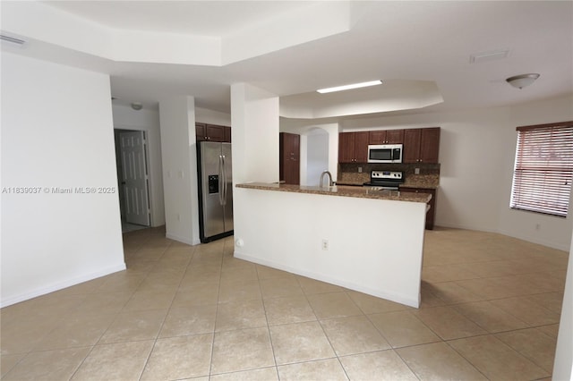 3001 SW 156th Ave, Miami, FL 33185 - kitchen featuring a tray ceiling, stainless steel refrigerator with ice dispenser, electric range oven, light tile patterned floors, and decorative backsplash
