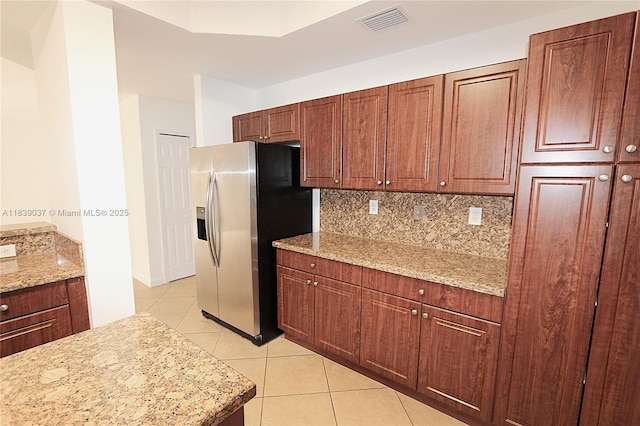 3001 SW 156th Ave, Miami, FL 33185 - kitchen featuring stainless steel fridge with ice dispenser, light tile patterned floors, tasteful backsplash, and light stone counters