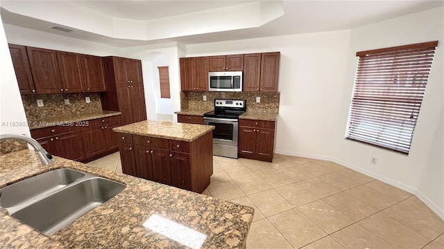 3001 SW 156th Ave, Miami, FL 33185 - kitchen featuring appliances with stainless steel finishes, tasteful backsplash, light tile patterned floors, and light stone countertops
